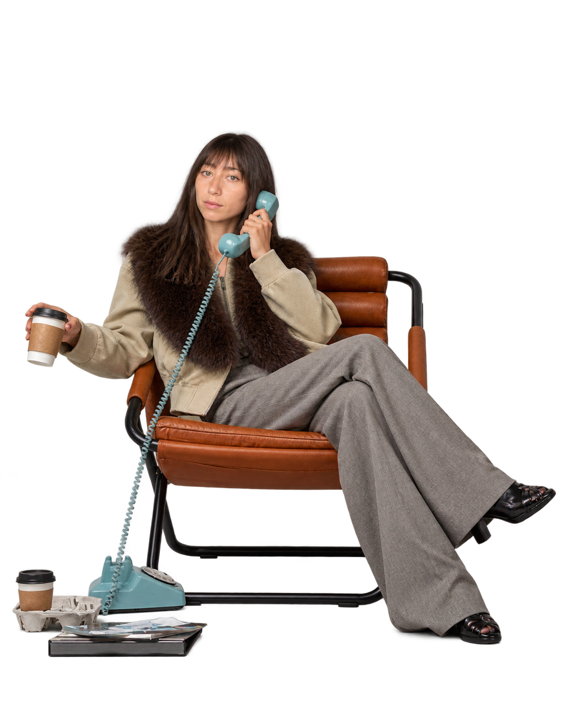 Sydney seated with a coffee and a telephone